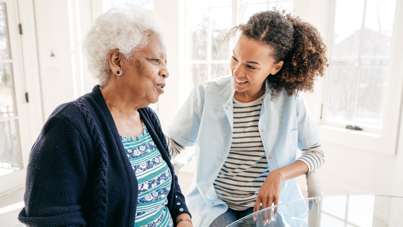 Home carer talking with an older person